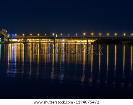 Night view of the Om River and the Komsomolsky bridge in Omsk, Siberia, Russia 