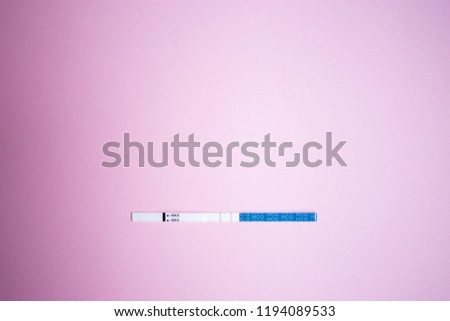 Positive pregnancy test with two strips. pink background, copy space