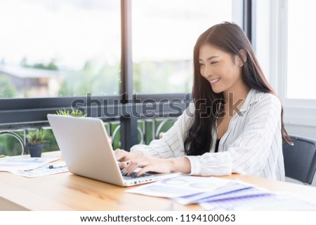 Asian young business women work from home new project modern loft,laptop in coffee shop cafe,Analyze plans,papers,  texting keyboard.design notebook quaratine coronavirus,technology startup business   Royalty-Free Stock Photo #1194100063