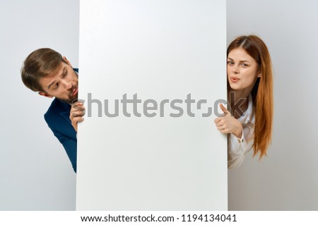 man and woman peeking out of workman mock-up, poster                          