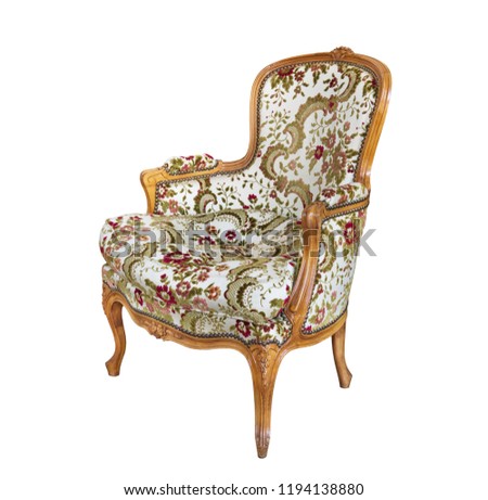 Antique armchair with upholstered fabric and wood trim. Isolated on white background.
