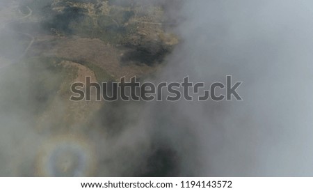 Aerial top down picture from above clouds revealing volcanic landscape near Mount Etna an active stratovolcano on the east coast of Sicily Italy near Catania