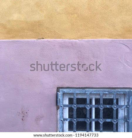 Window detail on pink and yellow wall