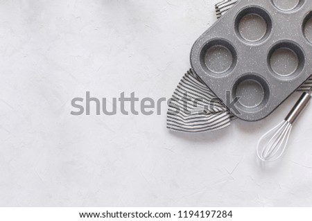 Kitchen utensils for baking - Cupcake metal mold Whisk on Crumpled Striped Napkin. Top view, Flat lay, Copy space. Minimal picture.
