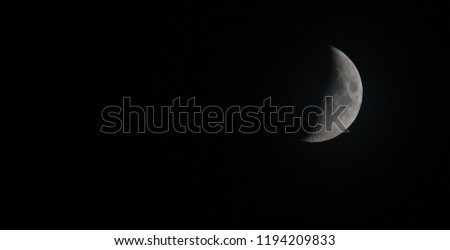 Half moon as earth satellite