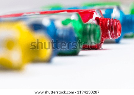 Colorful acrylic paint tubes on white background. Artistic background.