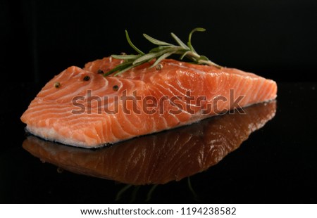 Salmon fresh on a black glossy background