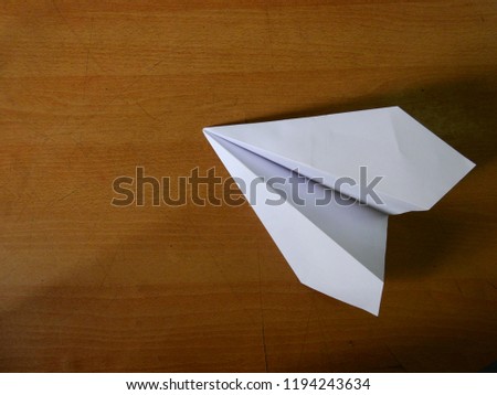 Paper rocket on wooden floor