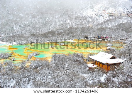 Huanglong National Park while snow is falling in winter. Royalty-Free Stock Photo #1194261406