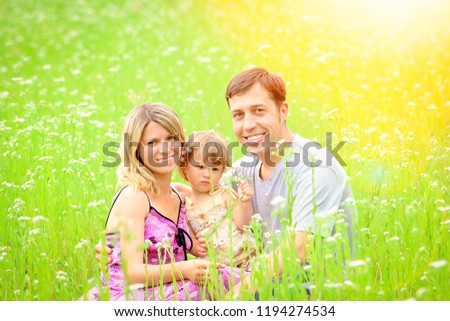 Family outdoors playing in the park on the grass