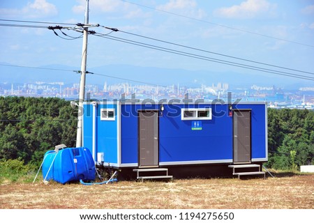 An outdoor toilet made by a container box