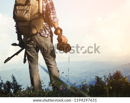 male traveler photographer fascinated by illuminated nature mountains