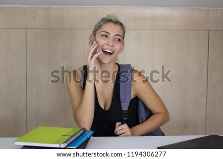 young and pretty student girl with mobile phone