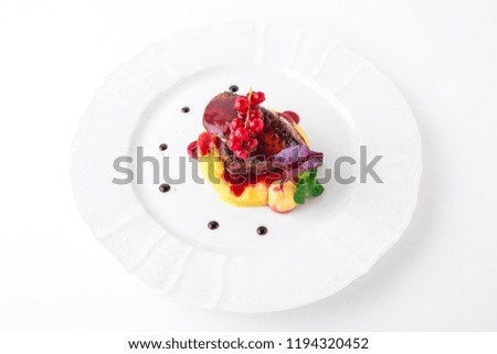 Foie gras with beef minion, mashed asparagus and  artichoke, with berry sauce. Banquet festive dishes. Fine dining restaurant menu. White background.