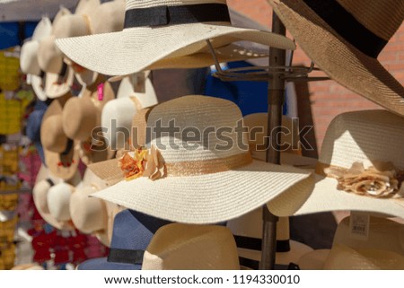 Straw hats outdoor on a stand a sunny day, picture from Northern Sweden.