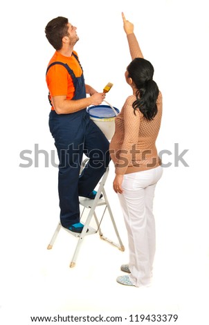 Pregnant woman showing to a painter man where to paint on the wall isolated on white background