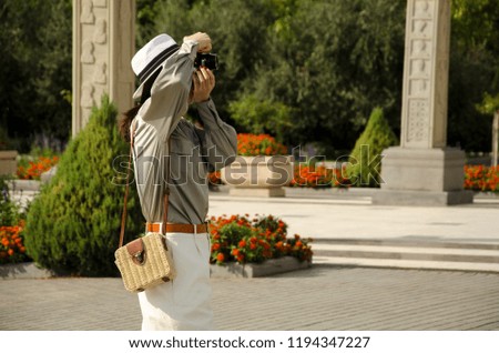 girl in a hat taking pictures