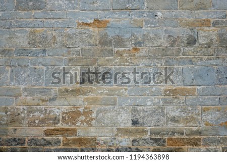 Colorful stone color of red blue brown green grey black and sky wall background.Background - Stacked Stone Wall with Lighting from Above side,Pebble stone composition as a background texture
