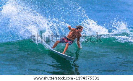 Riding the waves. Costa Rica, surfing paradise Royalty-Free Stock Photo #1194375331