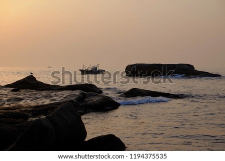 a ship silhouette behind the morning sunrise at the beach of sokcou in Korea