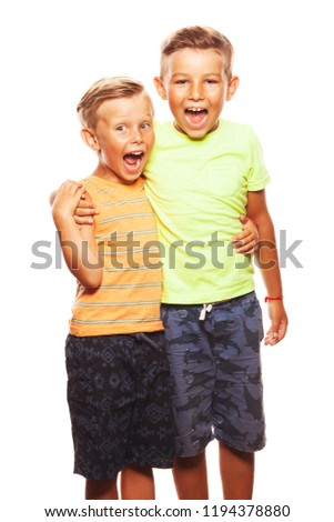 Ready for vacation concept. Portrait of two funny screaming siblings brothers posing for picture during family photo shooting: guys embrace each other. Happy faces. Studio shot