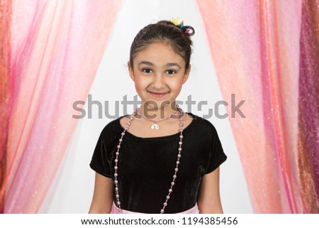 Smiling Studio Portrait of a Little Girl Playing Dress Up