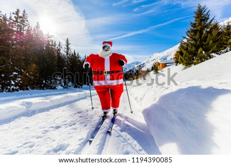 Santa Claus with Christmas suits with classic  nordic ski in snowy winter mountain ski resort landscape in sunny day, New Year's or xmas is coming.