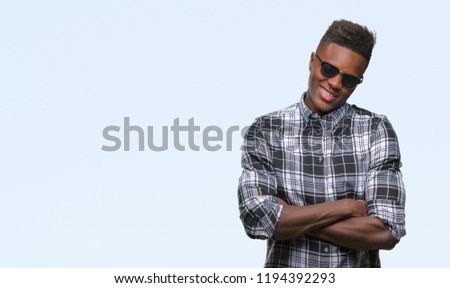 Young african american man wearing sunglasses over isolated background happy face smiling with crossed arms looking at the camera. Positive person.