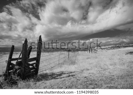 Rollings clouds over field in black and white