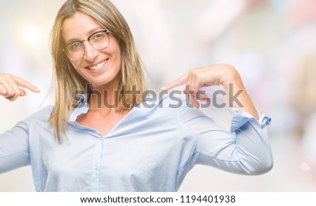 Young beautiful business woman over isolated background looking confident with smile on face, pointing oneself with fingers proud and happy.