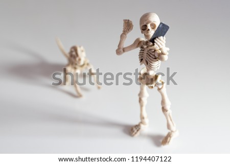 Selfie, skeleton taking self portrait with smartphone
