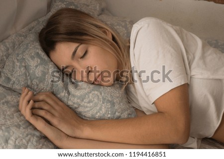 young girl sleeping in bed