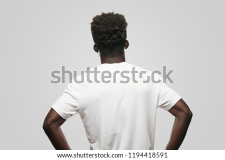 young cool black man sign. cut out person against monochrome background