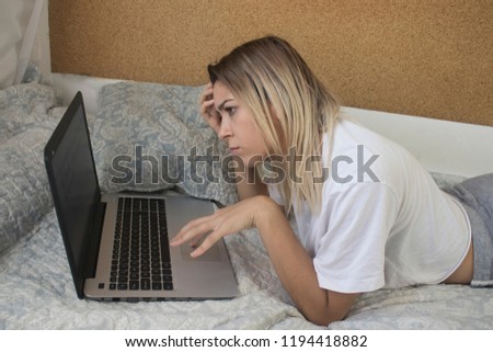 young girl with computer in bed