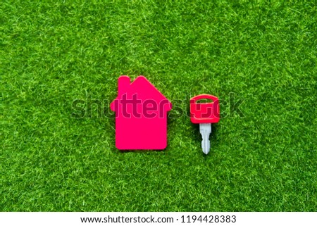 House, keys on a background of green artificial grass. real estate, insurance, purchase, sale of housing.