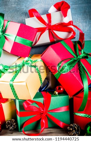 Christmas festive background with decorations and colorful gift boxes on wooden board