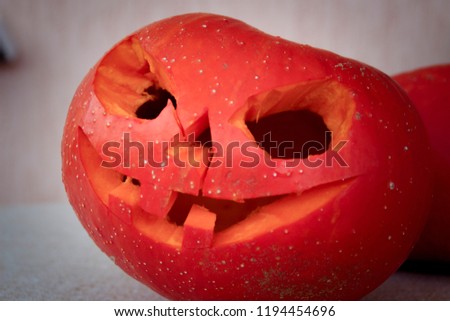 Autumn pumpkin. Halloween decoration. The scarlet face of a carved pumpkin. Thanksgiving day.