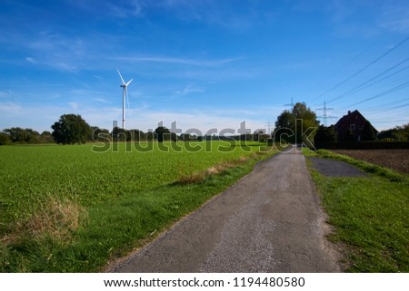 a windmill in a landscape picture