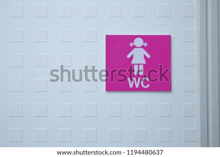 Restroom sign on a toilet door. WC Toilet icons set. Women WC signs for restroom. Women's Bathroom Icon Sign Restroom or Toilet room on the cement wall .