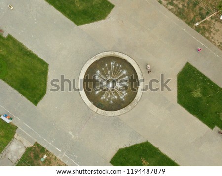 aerial top view of water fountain in the urban  public park on summer day