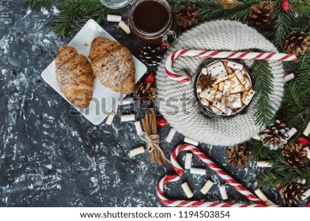Winter hot drink. Chocolate or cocoa with marshmallow, cookies, candy on dark background . Flat Lay.