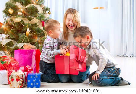 Christmas Kids. Happy Children Opening Gifts. Christmas Tree