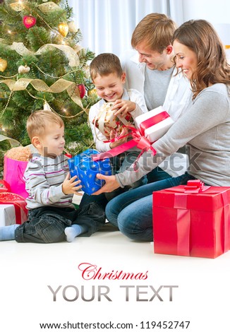 Christmas Family with Kids. Happy Family Opening Gift. Christmas tree