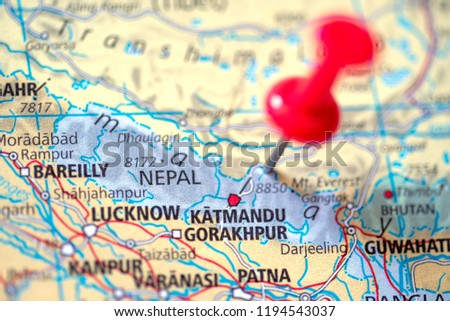 Push pin on the territory of Nepal on the world map