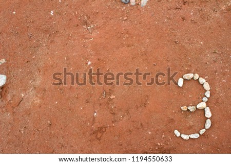 Number Three 3 Made Out of Rocks on Dirt Background powerpoint  