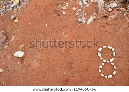 Number Eight 8 Made Out of Rocks on Dirt Background powerpoint  