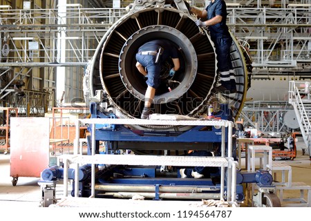 Jet engine remove from aircraft (airplane) for maintenance at aircraft hangar.Jet engine maintenance and change part by aircraft technician . Royalty-Free Stock Photo #1194564787