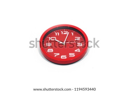 Red wall clock isolated on white background.