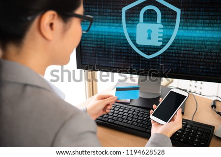 selective focus photo of young beautiful office worker using smartphone checking personal e-commerce information of her credit card