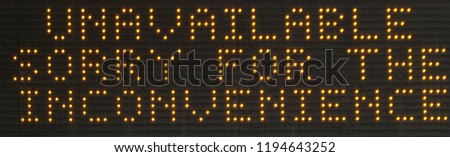 Dot matrix sign of LED lamp bulbs displaying the message "Unavailable sorry for the inconvenience". Zoomed in on a road sign that apparently lost its data connection